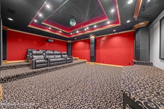 carpeted home theater with crown molding and a raised ceiling