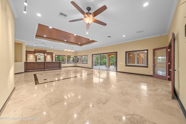 unfurnished living room featuring ceiling fan, ornamental molding, and a tray ceiling