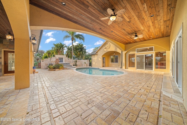 view of swimming pool featuring a patio and ceiling fan