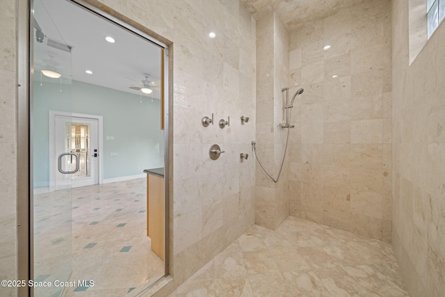 bathroom featuring a shower with door and ceiling fan