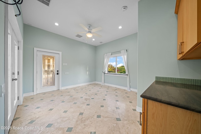 interior space with ceiling fan