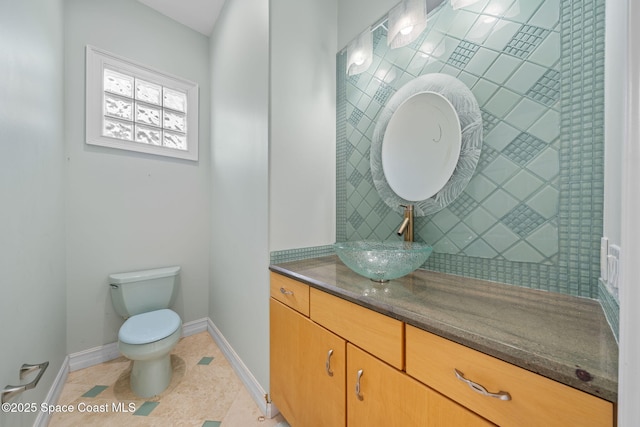 bathroom featuring tile patterned flooring, vanity, and toilet