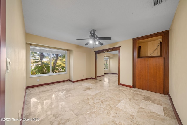 unfurnished room with ceiling fan