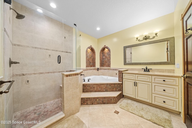 bathroom with vanity, plus walk in shower, and tile patterned flooring