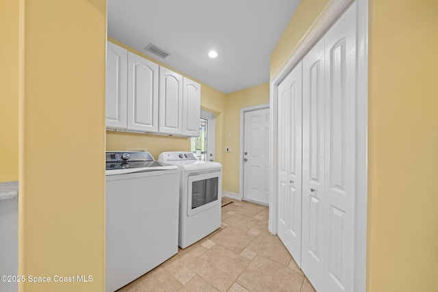 laundry area featuring cabinets and washing machine and clothes dryer