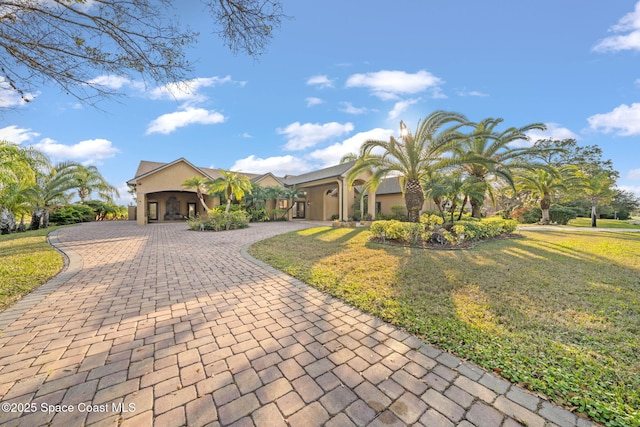 view of front of house with a front yard and a carport