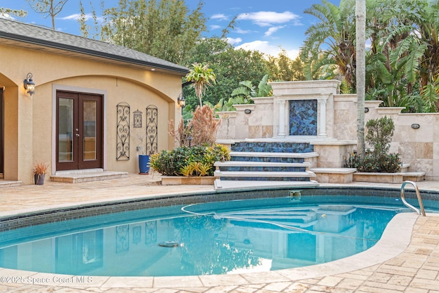 view of pool with a patio area and french doors