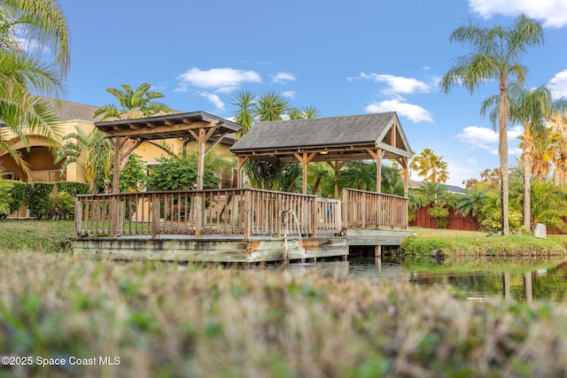 view of dock featuring a gazebo and a water view