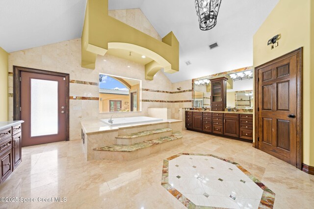 1855 Plantation Cir SE, Palm Bay, FL 32909 - bathroom with vaulted ceiling, a bath, vanity, and a walk in shower