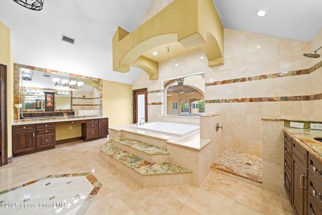 1855 Plantation Cir SE, Palm Bay, FL 32909 - bathroom with walk in shower, vanity, a bath, lofted ceiling, and recessed lighting
