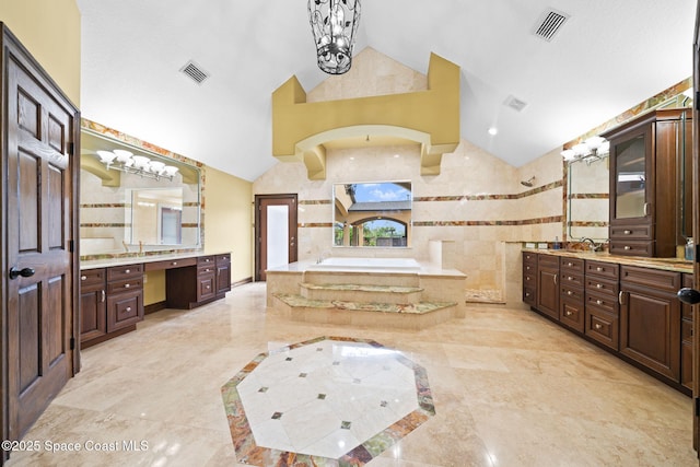 1855 Plantation Cir SE, Palm Bay, FL 32909 - full bathroom with a chandelier, vaulted ceiling, a garden tub, two vanities, and marble tiled flooring
