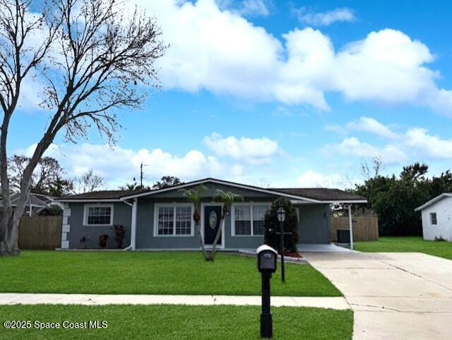 ranch-style house featuring a carport and a front lawn