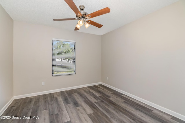 spare room featuring ceiling fan, dark hardwood / wood-style floors, and a textured ceiling