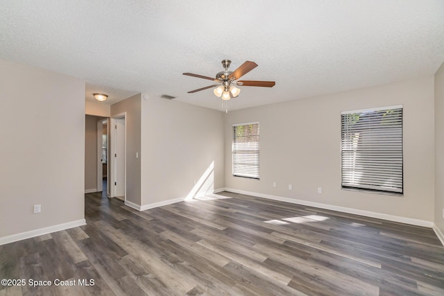 spare room featuring ceiling fan, dark hardwood / wood-style floors, and a textured ceiling