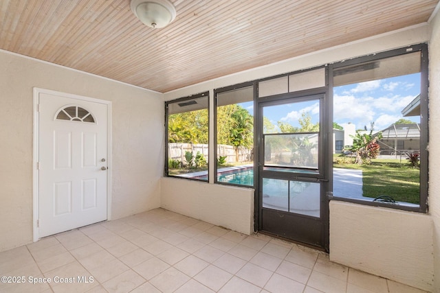 unfurnished sunroom with wood ceiling