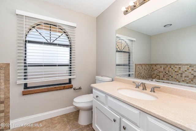 bathroom featuring vanity, a textured ceiling, decorative backsplash, tile patterned floors, and toilet