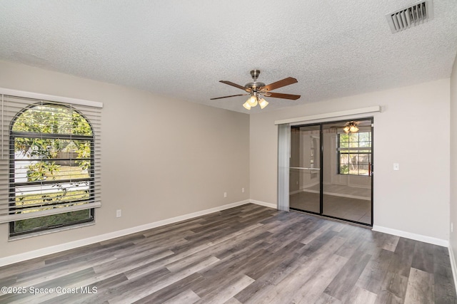 empty room featuring ceiling fan, hardwood / wood-style floors, and a textured ceiling