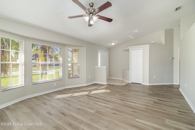 spare room with ceiling fan, lofted ceiling, and wood-type flooring