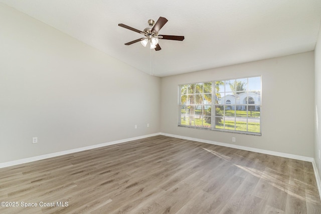 unfurnished room featuring vaulted ceiling, ceiling fan, and light wood-type flooring