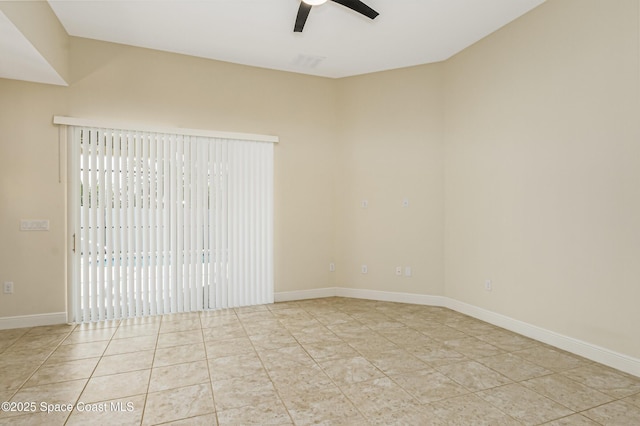 tiled spare room with ceiling fan