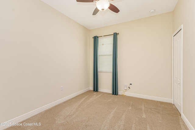 carpeted empty room with ceiling fan