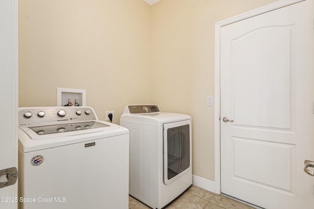 washroom featuring light tile patterned floors and washer and clothes dryer