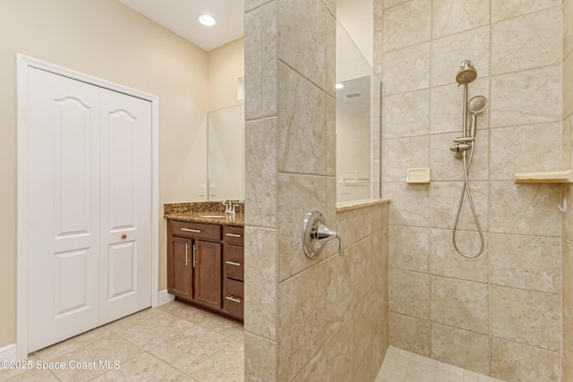 bathroom with vanity, tile patterned floors, and tiled shower