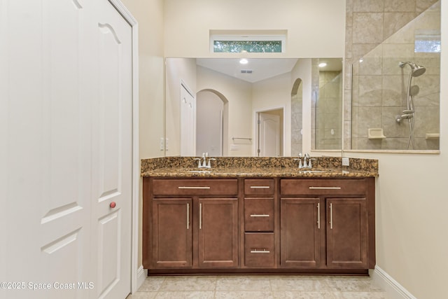 bathroom with vanity and tiled shower