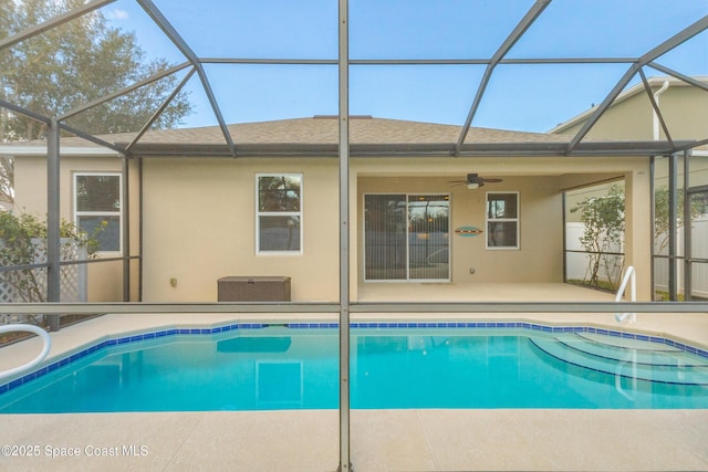 view of swimming pool featuring a lanai, a patio, and ceiling fan