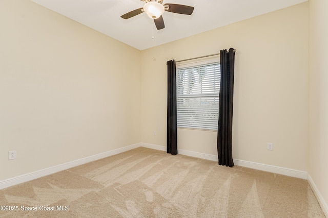 empty room featuring light colored carpet and ceiling fan