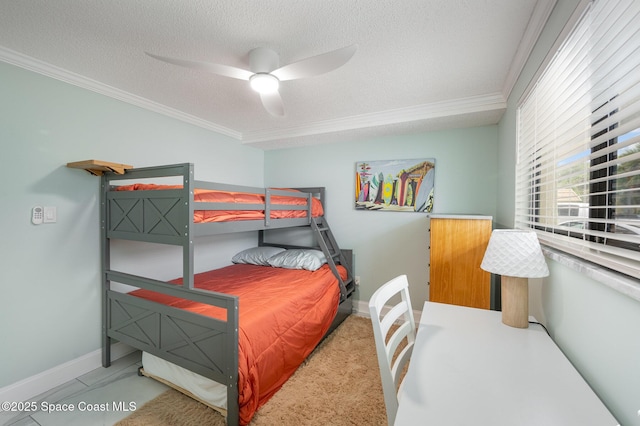 bedroom featuring ceiling fan, ornamental molding, and a textured ceiling