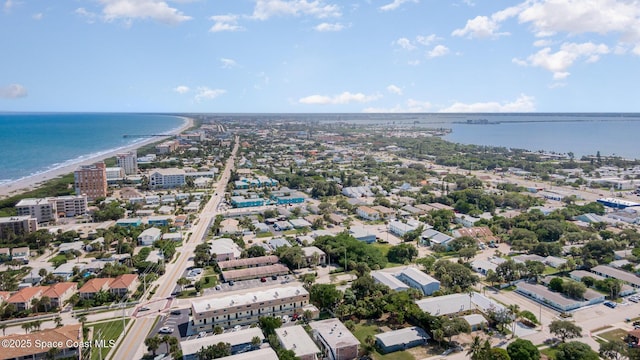 drone / aerial view featuring a beach view and a water view