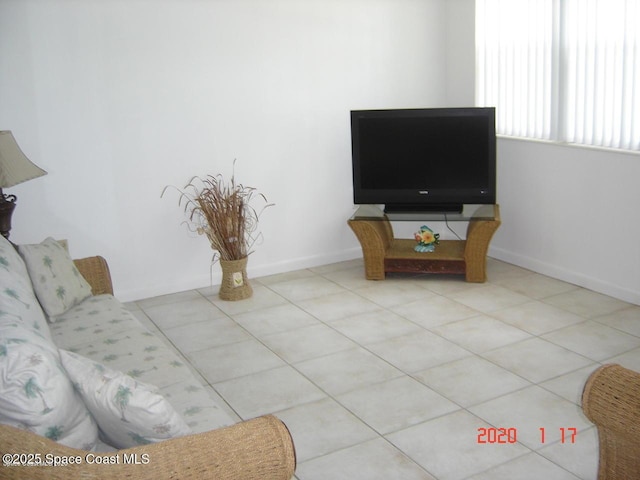 living room featuring light tile patterned floors and baseboards