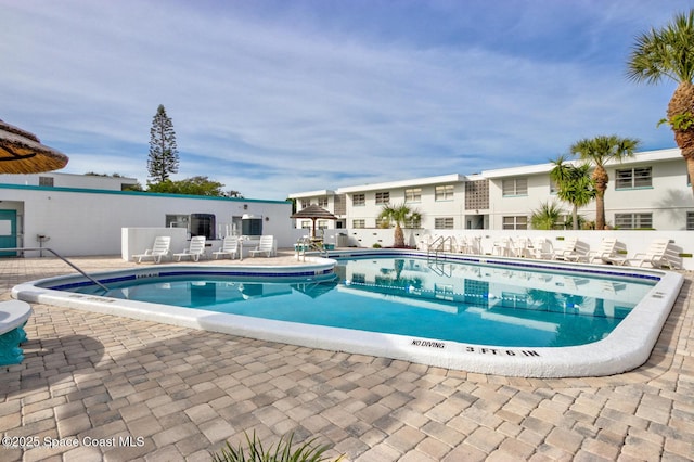 pool featuring a patio and fence