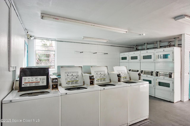 shared laundry area featuring washing machine and dryer and stacked washer / drying machine