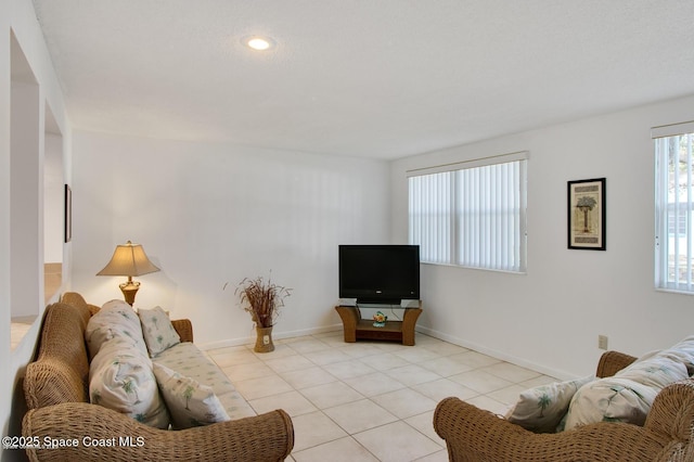 living room featuring light tile patterned flooring and baseboards