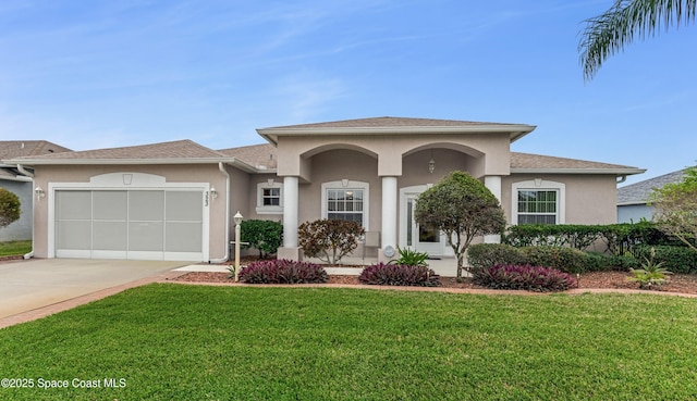 view of front of property featuring a garage and a front yard