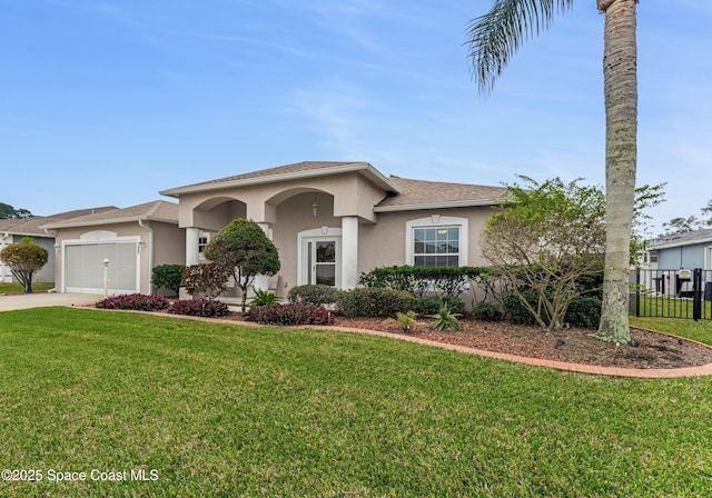 view of front of home with a garage and a front lawn