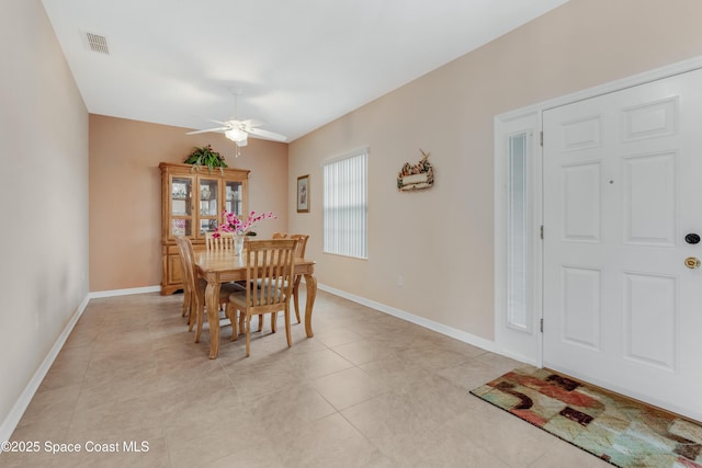 dining space with light tile patterned floors and ceiling fan