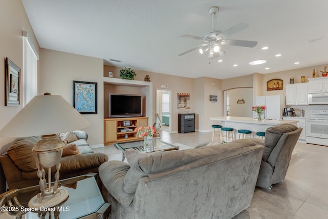 living room featuring light tile patterned floors and ceiling fan