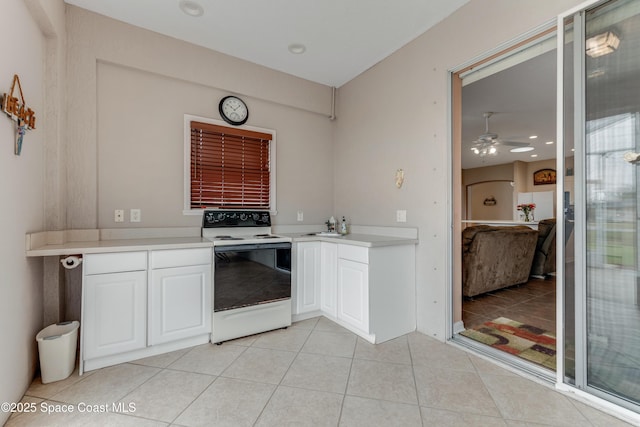 kitchen featuring white cabinetry, ceiling fan, white electric range, and light tile patterned floors