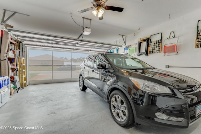 garage with a garage door opener and ceiling fan