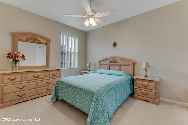 bedroom featuring light carpet and ceiling fan