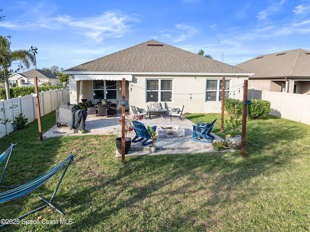 rear view of house with a lawn and a patio area