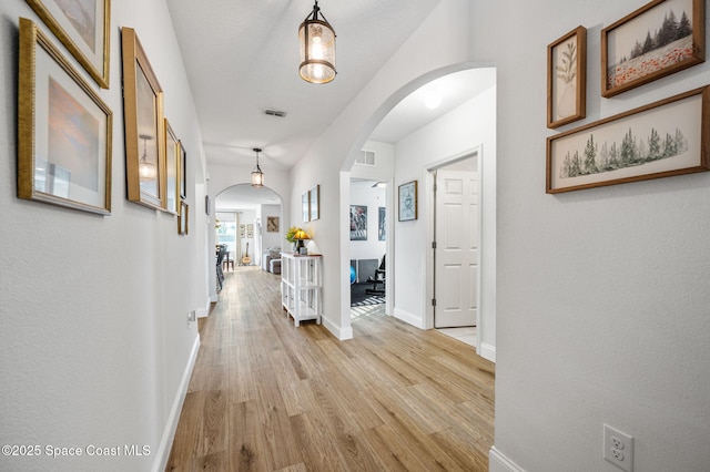 hallway with light hardwood / wood-style floors