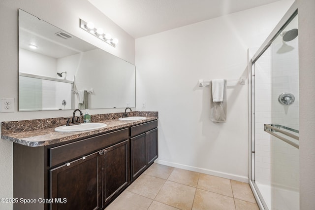 bathroom featuring tile patterned flooring, vanity, and an enclosed shower