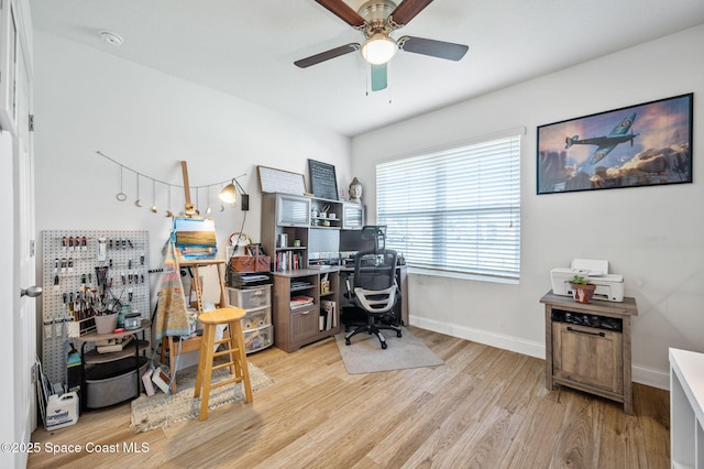 office featuring light hardwood / wood-style floors and ceiling fan