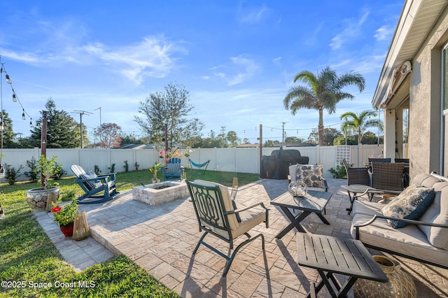 view of patio / terrace with an outdoor living space with a fire pit