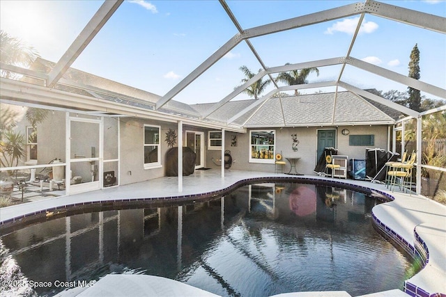 view of swimming pool with a lanai and a patio area