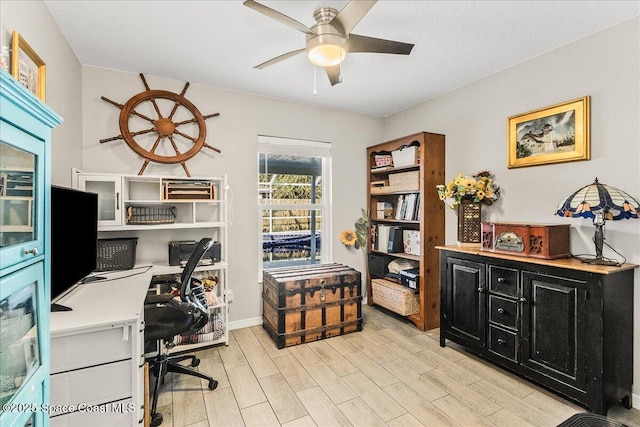 office with ceiling fan and light hardwood / wood-style flooring